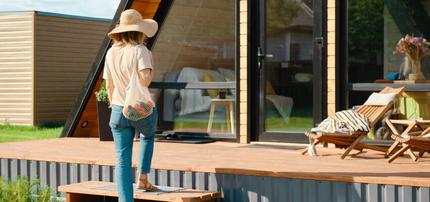 adult-woman-returns-from-the-market-to-a-wooden-ho-2026-03-17-05-08-27-utc